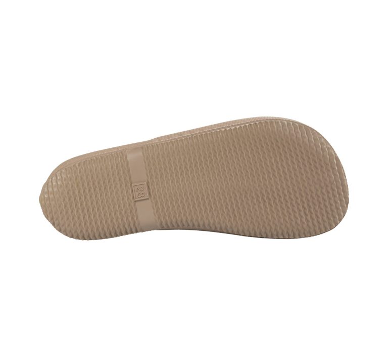 Beige Schuhsohle mit rutschfester Textur und einem schmalen Band.